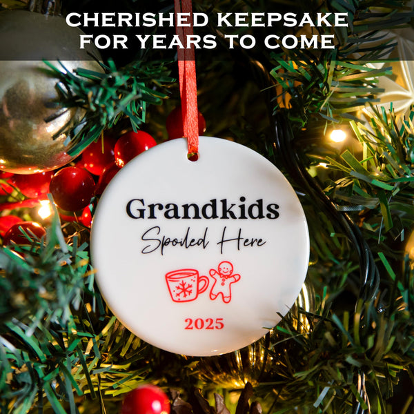 Christmas ornament with 'Grandkids Spoiled Here' text on a decorated tree.