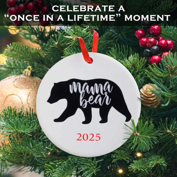 Decorative ornament with 'mama bear' and '2025' on a Christmas tree.