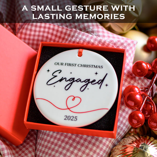 Engagement ornament with 'Our First Christmas Engaged 2025' text in a red box on a checkered fabric background.