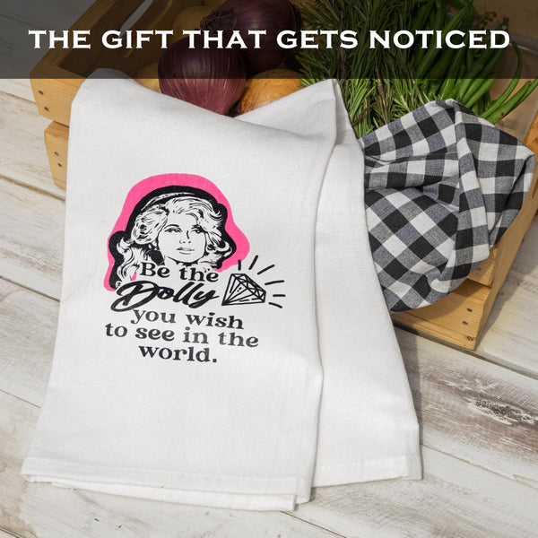 White towel with graphic design and text on a wooden surface