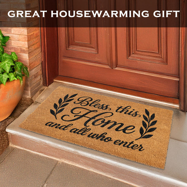Doormat with 'Bless this Home and all who enter' text on a wooden door step.