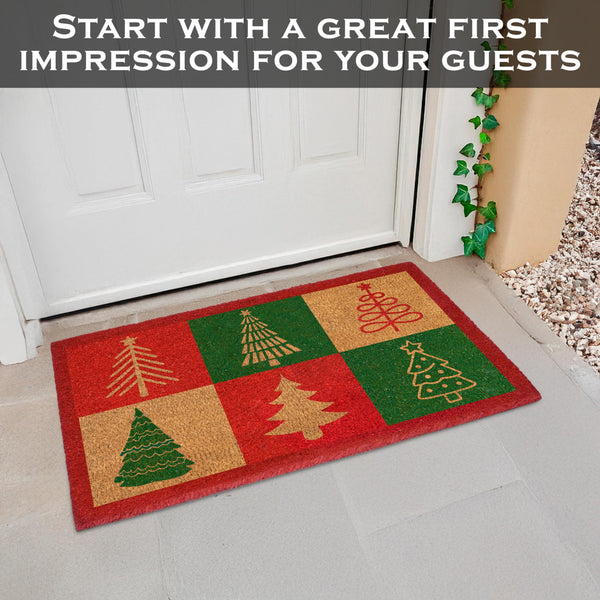 Decorative doormat with Christmas tree pattern on a white door step