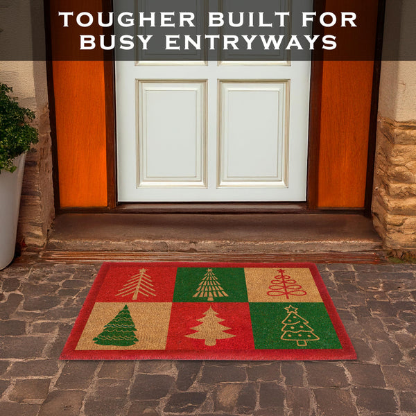 Doormat with Christmas tree design in front of a door, text 'Tougher Built for Busy Entryways' above.