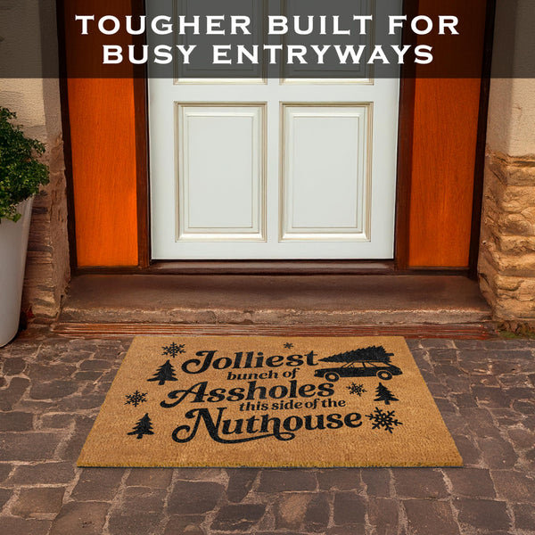 Doormat with humorous text in front of a house entrance