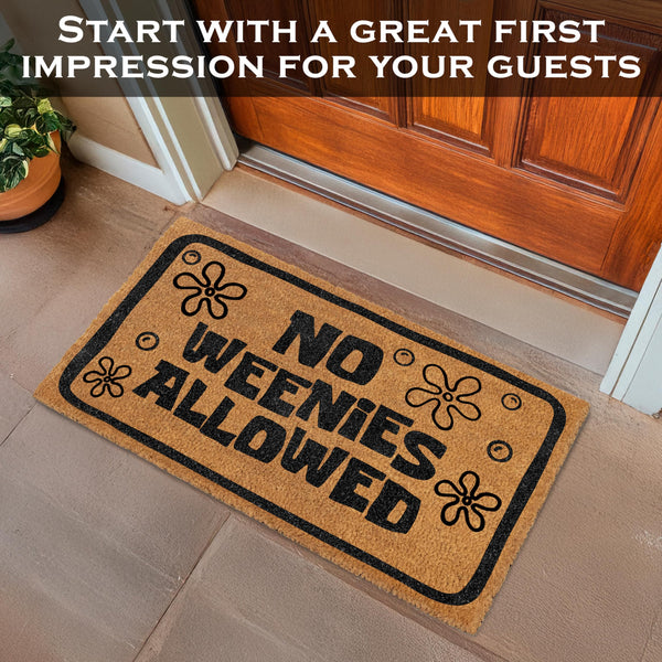 Doormat with 'No Weenies Allowed' text in front of a wooden door.