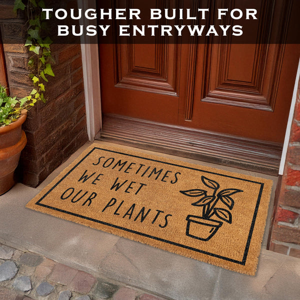 Doormat with humorous text and plant illustration on a doorstep, with text 'Tougher Built for Busy Entryways' above.