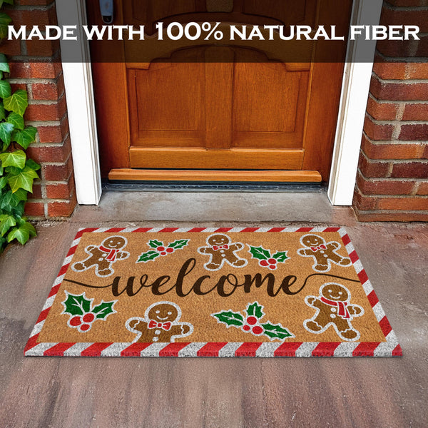 Decorative doormat with gingerbread men and holly design in front of a wooden door.