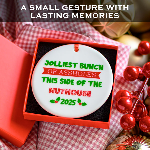 Decorative Christmas ornament with humorous text in a red box, surrounded by festive items.