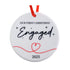 Round ornament with 'Our First Christmas Engaged 2025' text on a white background