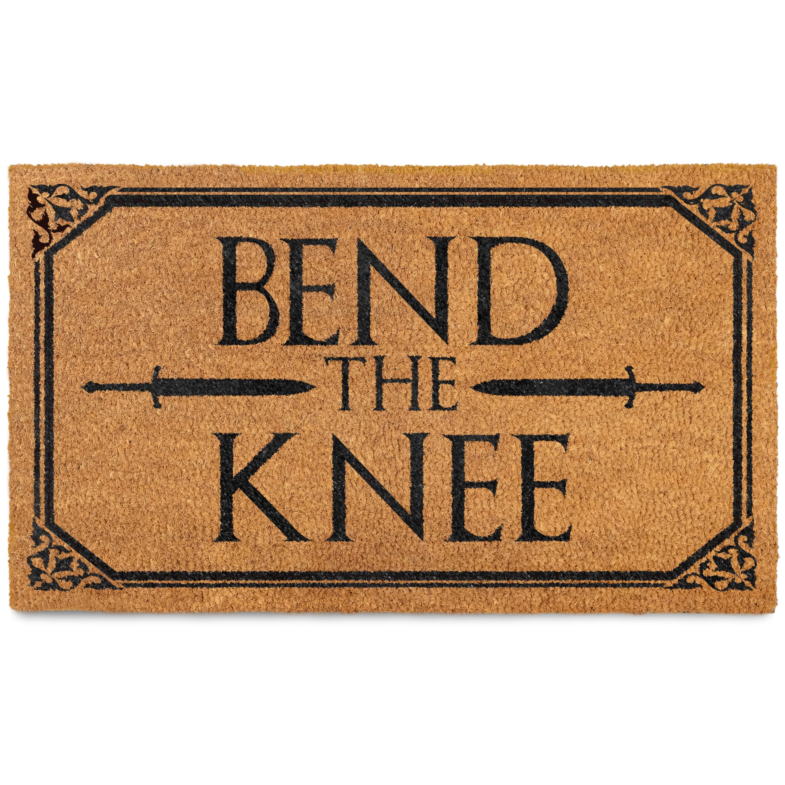 Rectangular coir door mat with the text 'BEND THE KNEE' in bold capital letters, centered, with decorative elements around the border.