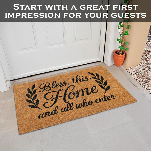 Doormat with 'Bless this Home and all who enter' text on a gray floor.
