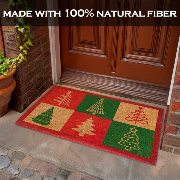 Decorative doormat with Christmas tree design on a stone porch.