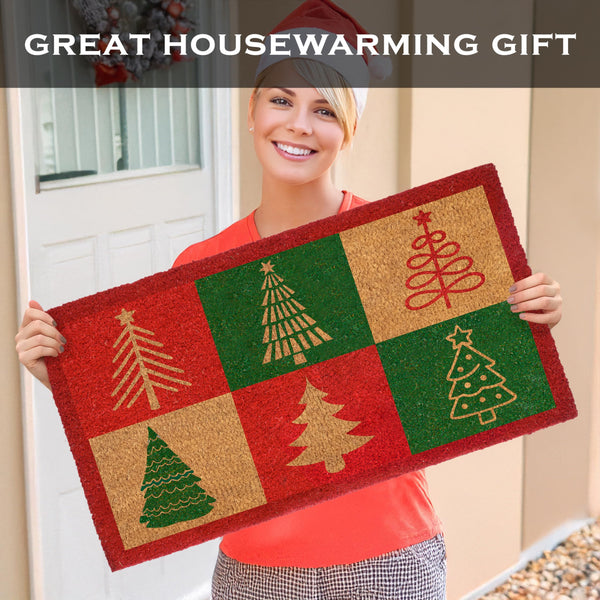 Person holding a Christmas-themed doormat with decorative trees, suitable for housewarming gifts.