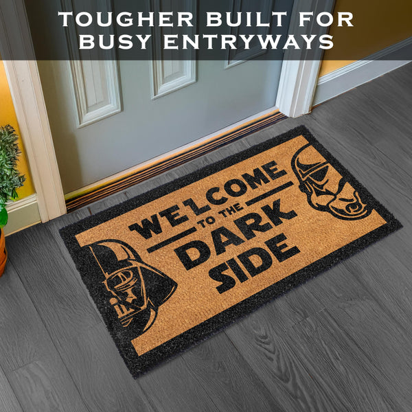 Doormat with Darth Vader design and text 'Welcome to the Dark Side' on a gray floor.